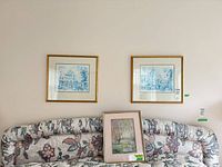 Overall view showing three framed prints: two Paris street scenes above, one pastoral landscape below