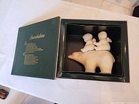 Figurine seated in open original box