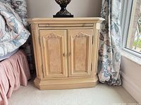 Full view of Thomasville light blonde nightstand showing top, drawer, doors, and base