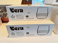 Stacked Vera boxes showing brand, importer, origin and glass illustration