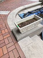Rectangular decorative concrete planter on step