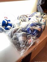 Multiple bags of blue and grey yarn skeins with labels visible on countertop