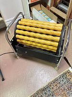 Overall view of massage roller showing wood rollers and chrome frame