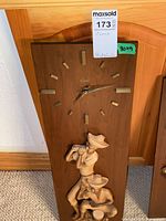 Full view of wooden wall clock showing brass markers, hands, and resin musician figures