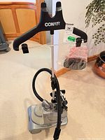Full view of Conair upright garment steamer showing hanger, pole and base