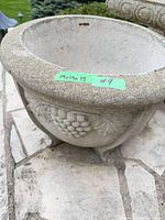 Top view of concrete urn planter showing interior, rim and size tape label