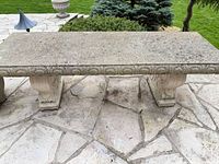 Full view of concrete bench showing top surface and both pedestal legs
