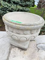 Front angled view showing urn bowl, pedestal, weathered surface