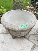 top view of concrete urn planter showing rim, interior and size tape