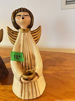 Front view of ceramic angel candle holder with height tag visible