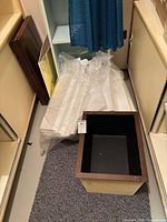 Planter box and stack of foam boards on floor
