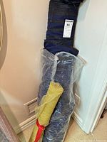 Blue velvet fabric roll with MaxSold label and protective plastic wrap