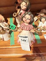 Front view of three Bozner angel figurines showing size and paint details