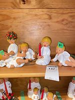 All five porcelain angel figurines on shelf