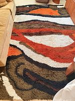 Full view of abstract shag rug laid out on floor
