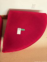 Top view of red velvet quarter-round ottoman base