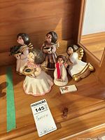 Five Thun angel figurines arranged on shelf