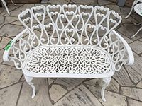 Front view of white ornate cast aluminum outdoor bench