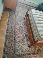 Full view of rug beside bed showing overall pattern and border