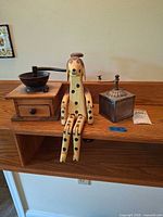 Wood box coffee grinder, wooden dog, metal grinder on shelf