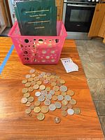 Full lot view showing basket, coin folder, tag and scattered coins