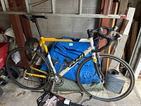 Left side view of Fuji road bicycle showing frame graphics, flat tires, missing pedals