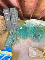 Five fencing pieces: two steel rolls, two green plastic rolls, one flat panel