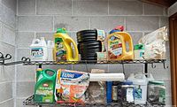 Shelf with assorted garden chemicals, black edging coils and containers