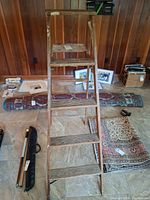 Front view of wood A-frame ladder with steps visible