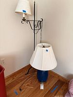 Both lamps standing together on wood floor