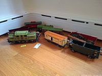 Group shot of locomotive and six cars on floor
