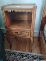 full view of nightstand front showing open shelf, drawer, legs