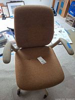 Front view showing full chair, upholstery and armrests