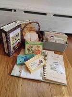 Overview of binders, card boxes, basket and recipe cards on floor