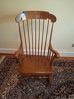 Front view of wood rocking chair showing full design