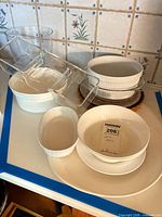 Group view showing clear glass trifle bowl, divided tray and assorted white ceramic dishes