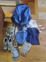Overall lot showing luggage cart, backpack, shoes, gloves, balaclava and bags