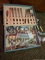 Open flatware chest showing entire set pieces