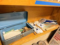 Open blue metal toolbox with contents