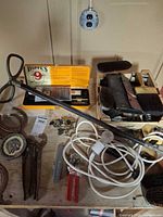 Overview of lot showing Jeep emblem, horseshoes, Hoppe’s kit, brushes, drafting tools, pliers, cutters, cords