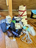 Overall lot showing canvas tote, shoe bags, assorted pouches, adapters, extension cord