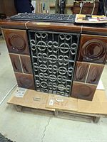 Front view showing ceramic tiles and iron scroll door
