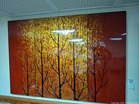 Front view of the three-panel tree silhouette wall art mounted on wall