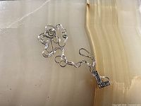 Entire necklace and pendant laid flat for scale and overall view