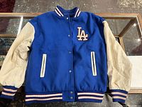 Front view of LA Dodgers bomber jacket showing body, sleeves, pockets and ribbed trim
