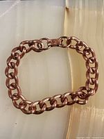 Copper chain bracelet laid flat showing links and clasp