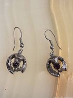 Front view showing both earrings, design and stones