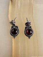 Front view of sterling earrings showing cabochon stones and rope detailing