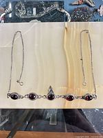 Full view of sterling necklace showing chain and five red cabochon settings