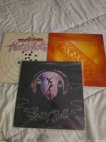 Front view of all three album covers